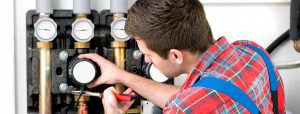 A heating technician working on a heater.
